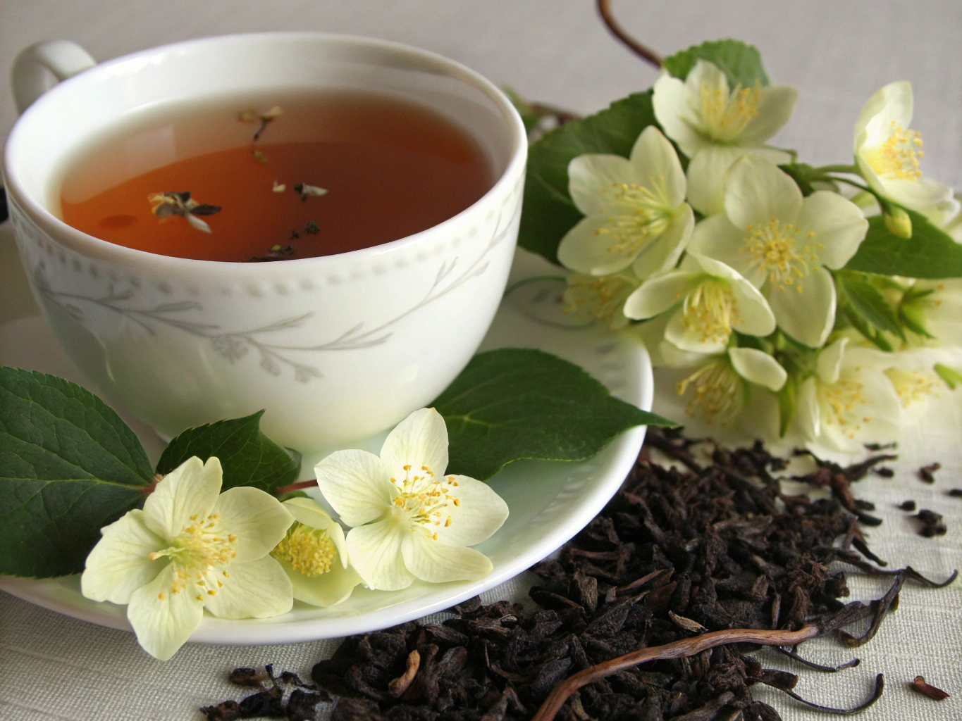 Steaming cup of Earl Grey tea with a slice of fresh bergamot